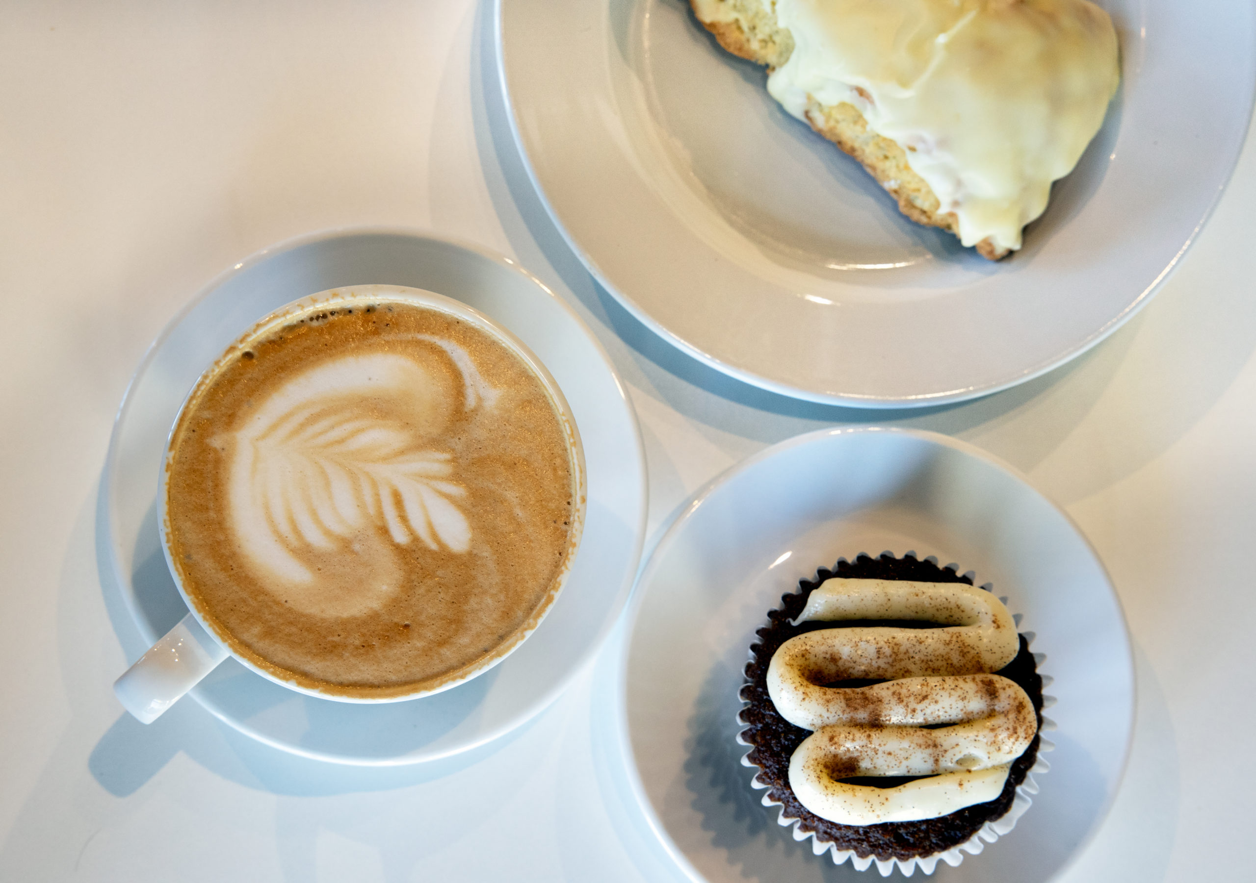 A cup of coffee and two desserts