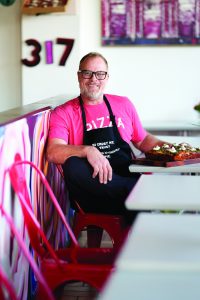 Man seated with pizza